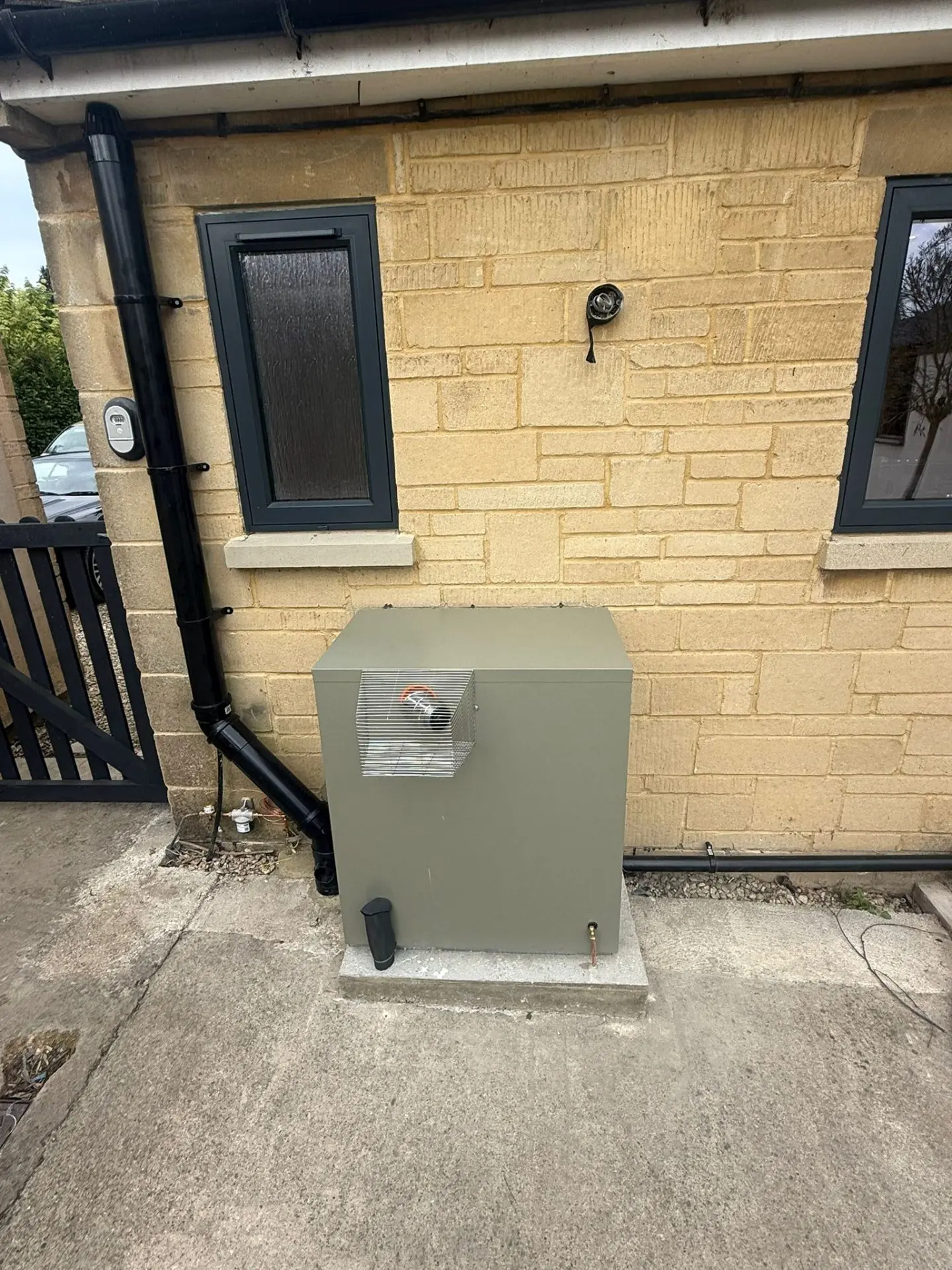 Air source heat pump installed at a Cotswold stone home in Oxfordshire